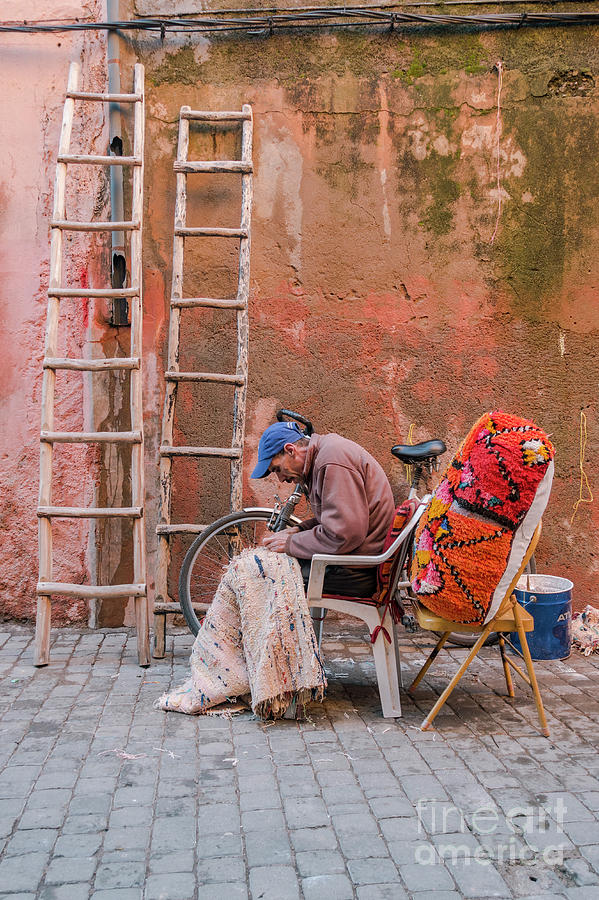 Man Working On A Moroccan Rug In The Street Photograph