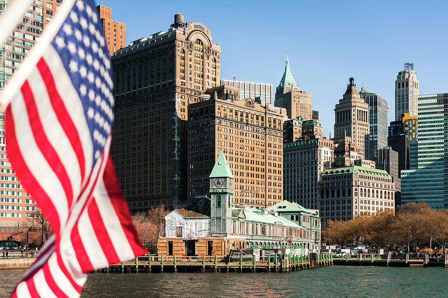 Manhattan and american flag Photograph by Philippe Lejeanvre
