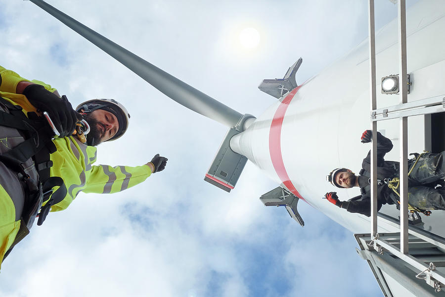 Manual high workers working on biggest wind-turbine Photograph by CharlieChesvick
