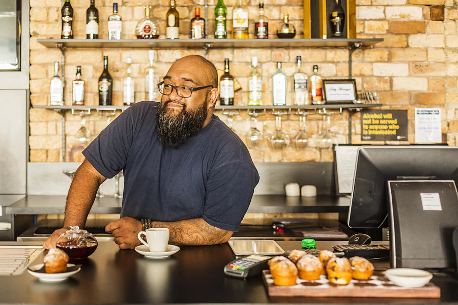 Maori Businessman Working in a New Zealand Bar or Cafe Photograph by Davidf