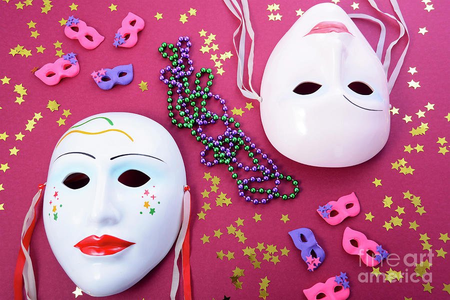 Mardi Gras masks with party decorations.  Photograph by Milleflore Images