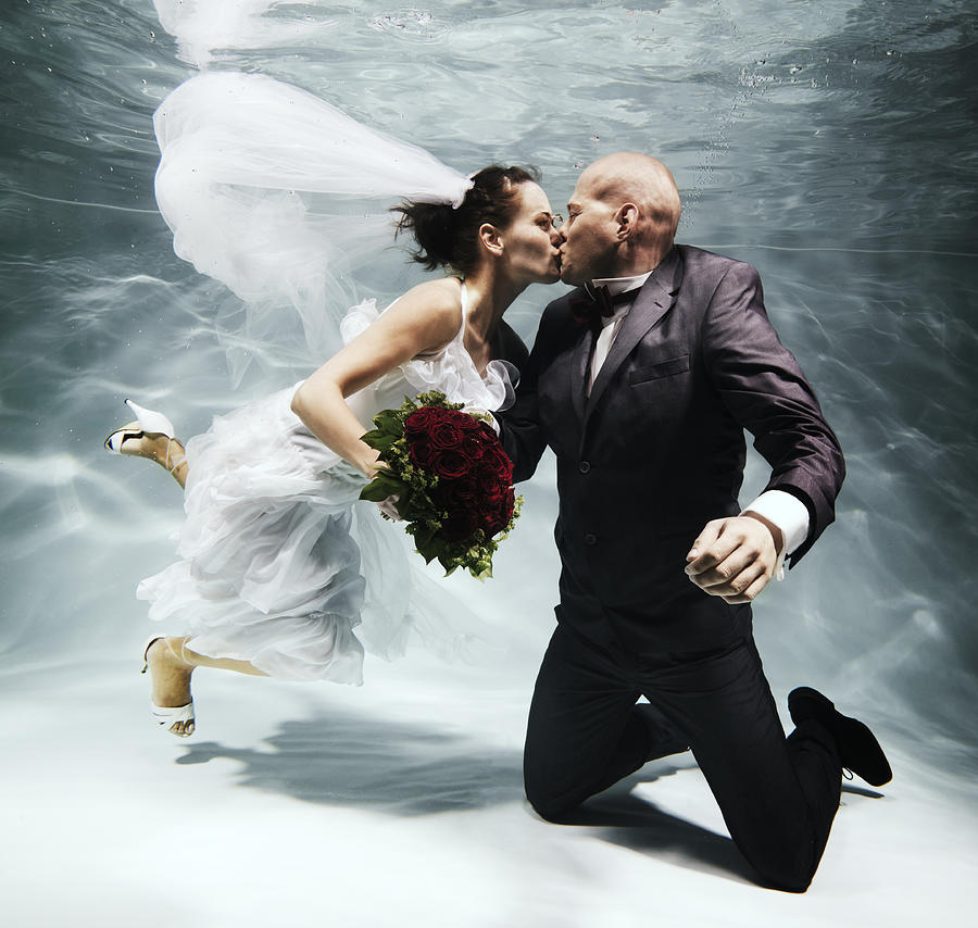 Marriage couple kissing under water Photograph by Henrik Sorensen