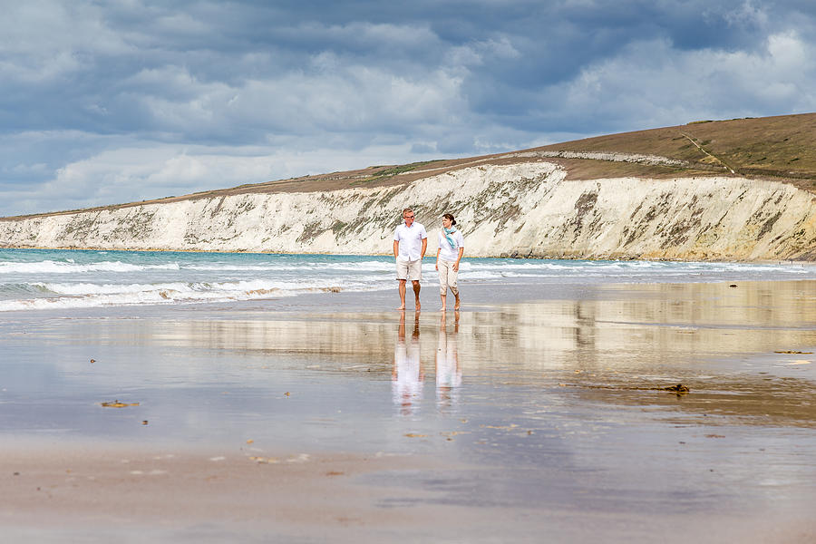 Married couple walking along the beach Photograph by s0ulsurfing - Jason Swain