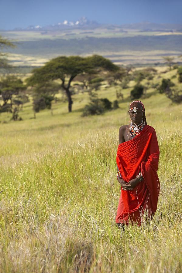 Masai Warrior in red surveying landscape of Lewa Conservancy, Kenya Africa Photograph by VisionsofAmerica/Joe Sohm