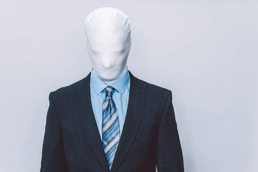 Masked businessman. Photograph by Guido Mieth