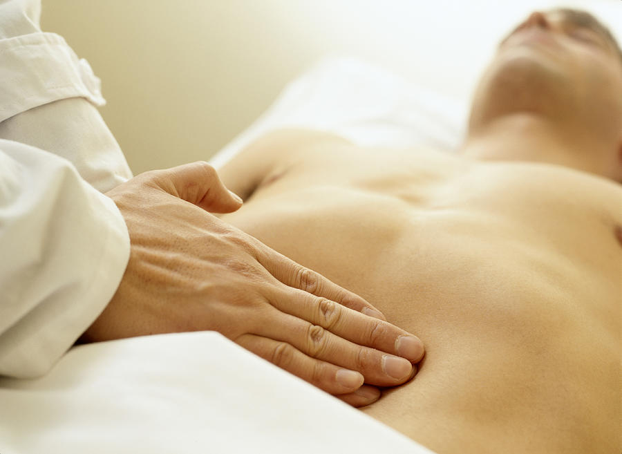 Massage Therapist Palpating the Abdomen Photograph by Ryan McVay