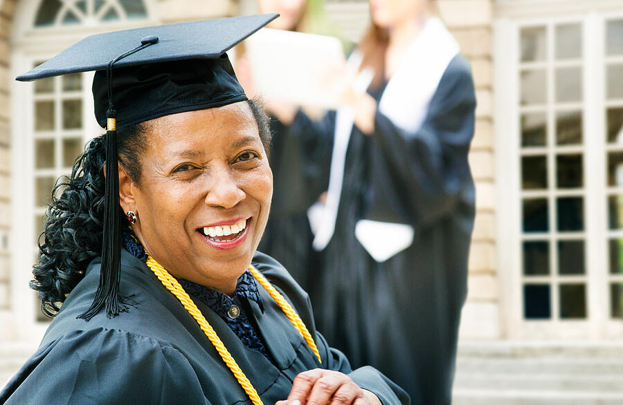 Mature African American woman on graduation day Photograph by NicolasMcComber