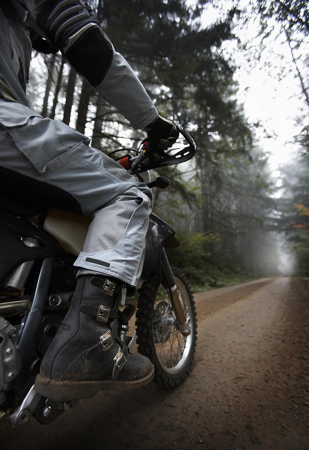 Mature biker riding in forest, low section Photograph by Thomas Northcut