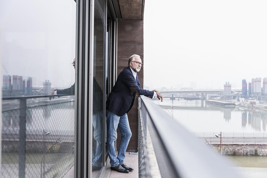 Mature businessman standing on balcony Photograph by Westend61