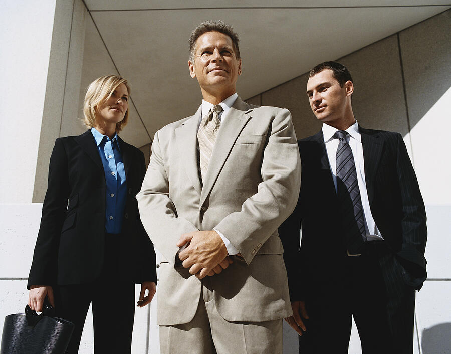 Mature CEO Businessman Outdoors Standing Confident With Male and Female Colleagues Photograph by Digital Vision.