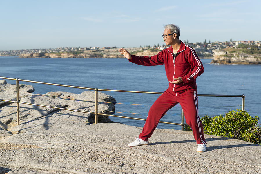 Mature Chinese Man Practising Tai Chi Chuan in Park Photograph by Catchlights_sg
