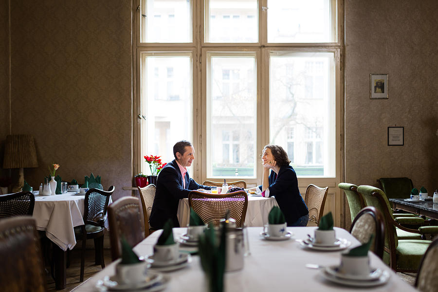 Mature couple having breakfast in an old hotel Photograph by Hinterhaus Productions