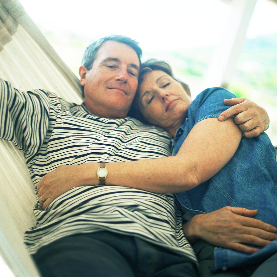 Mature couple hugging in hammock Photograph by Patrick Sheandell OCarroll