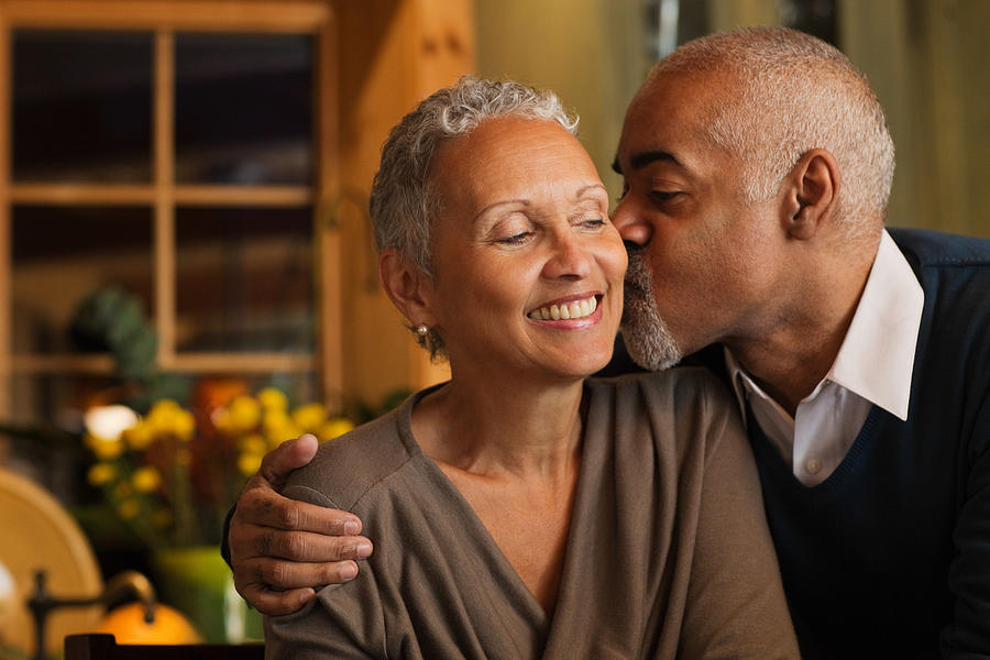 Mature couple kissing Photograph by Image Source