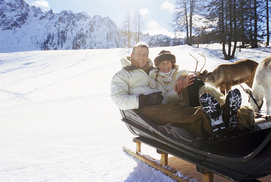 Mature Couple Sitting in a Sled Photograph by Michelangelo Gratton