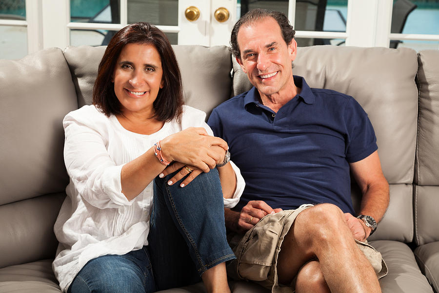 Mature couple sitting on couch Photograph by Juan Silva