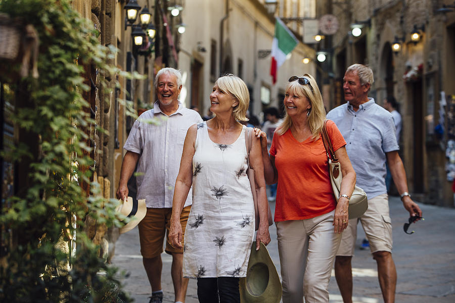 Mature Couples Looking Around Old Town Italy Photograph by SolStock