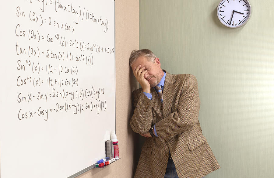 Mature depressed maths teacher Photograph by Peter Dazeley