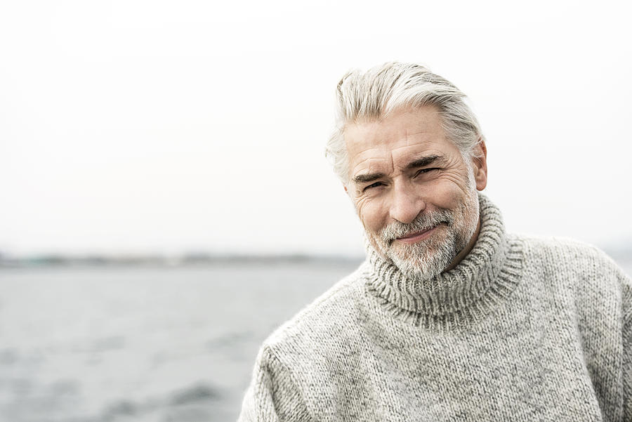 Mature grey haired man wearing a sweater Photograph by Robin Skjoldborg