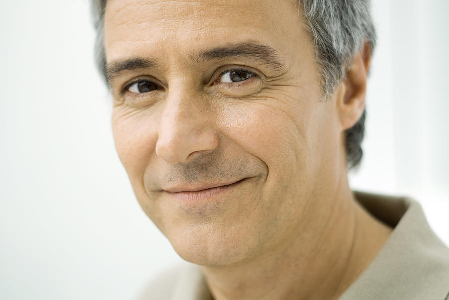 Mature man smiling at camera, portrait Photograph by PhotoAlto/Eric Audras