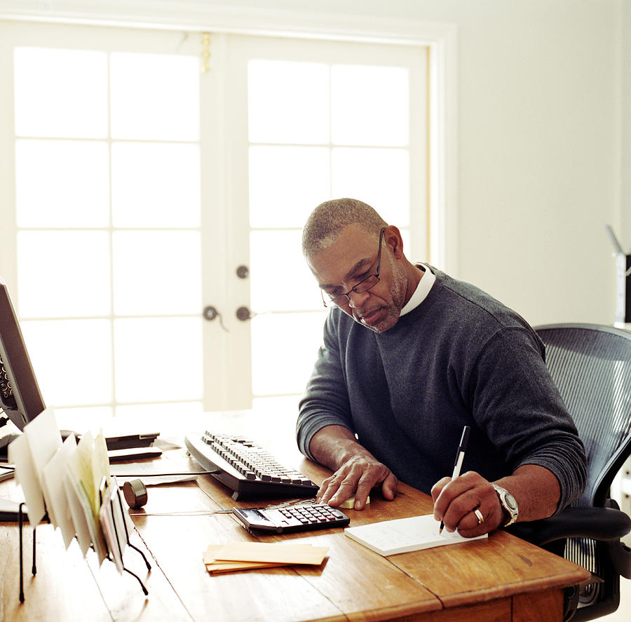 Mature man working in  home office Photograph by Siri Stafford