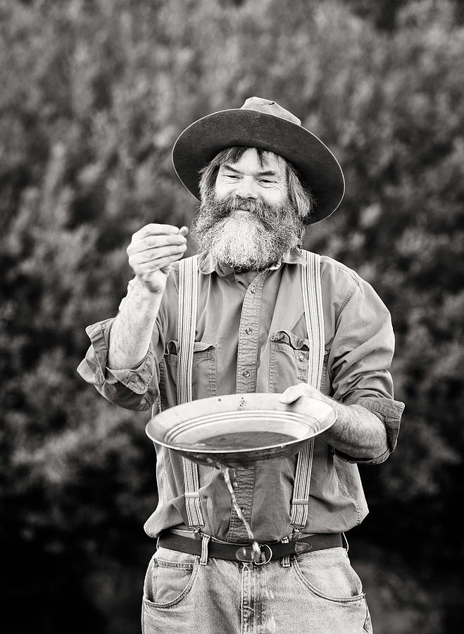 Mature prospector panning for gold vertical Photograph by NicolasMcComber