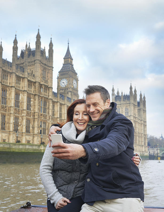 Mature tourist couple photographing selves and Houses of Parliament, London, UK Photograph by Frank and Helena