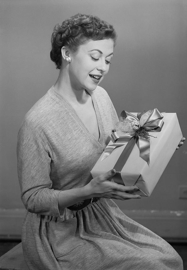 Mature woman holding gift box Photograph by George Marks