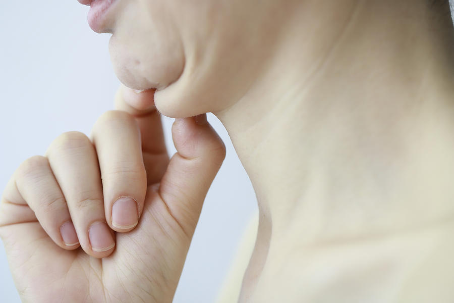 Mature woman touching double chin,close up Photograph by Runstudio