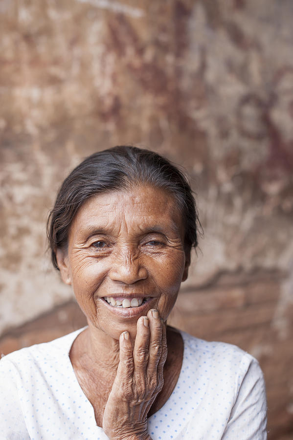 Mature woman with hand on chin, Bagan, Burma Photograph by Cultura Exclusive/yellowdog
