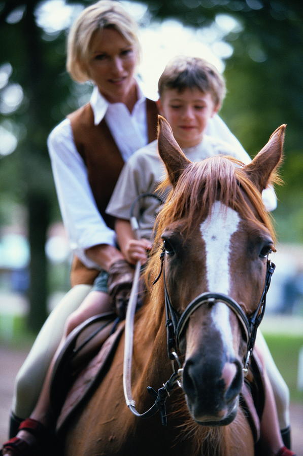 Mature Woman With Son (6) Riding Horse Photograph by Romilly Lockyer