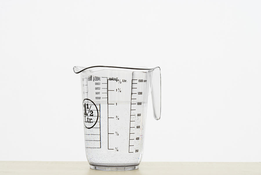 Measuring jug on white background Photograph by Foodcollection RF