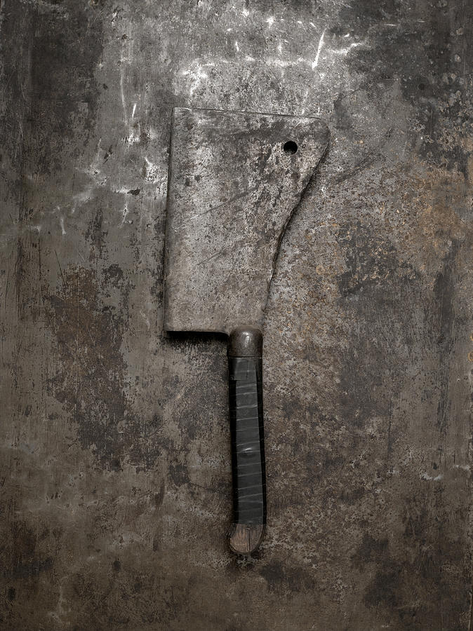 Meat cleaver on metal background, overhead view Photograph by Jonathan Kantor
