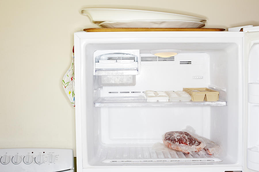 Meat inside open freezer Photograph by Alexander Nicholson