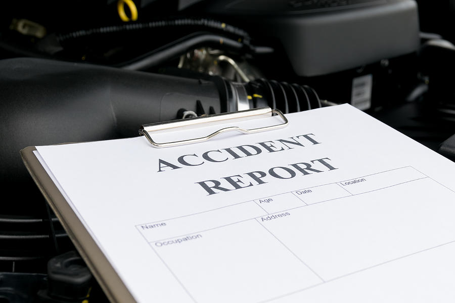 Mechanic Inspecting damage car and filling in accident report fo Photograph by Zenstock