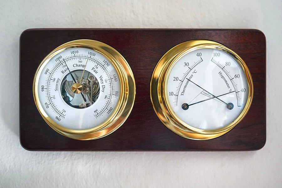 Mechanical weather station mounted on a wooden plate. Photograph by Emreturanphoto