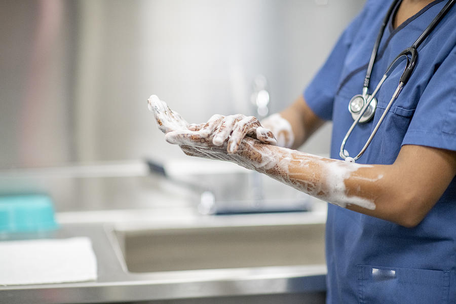 Medical Personnel Hand Washing Dressed in Medical Scrubs stock photo Photograph by FatCamera
