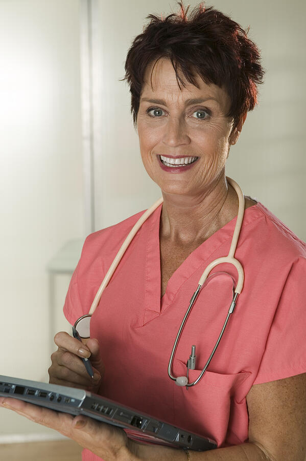 Medical professional using tablet computer Photograph by Comstock Images