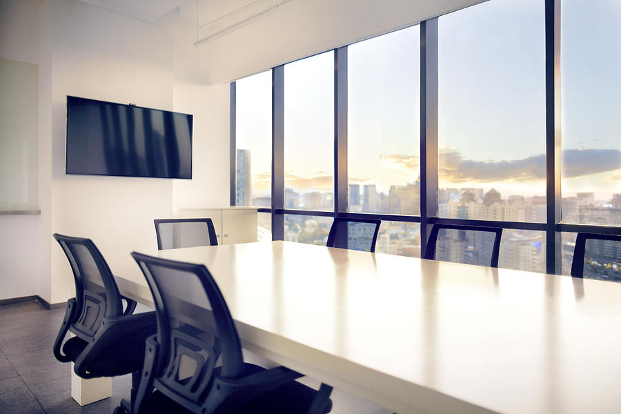 Meeting room with view of cityscape sunset Photograph by Shannon Fagan