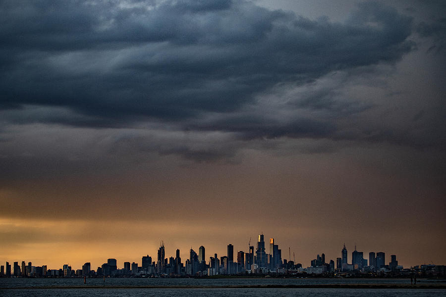 Melbourne skyline in golden light under a grey sky. Photograph by Leigh Henningham