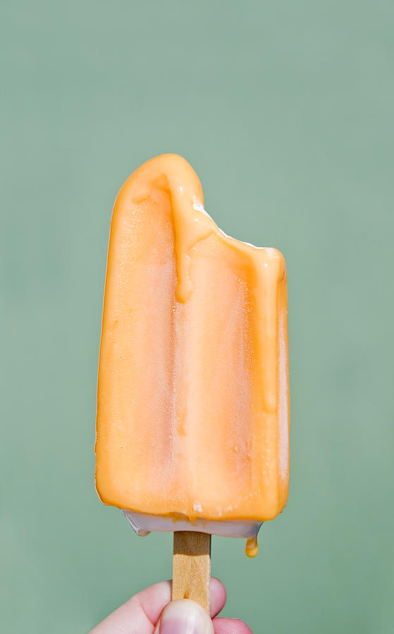 Melting Orange Popsicle Photograph by Charity Burggraaf