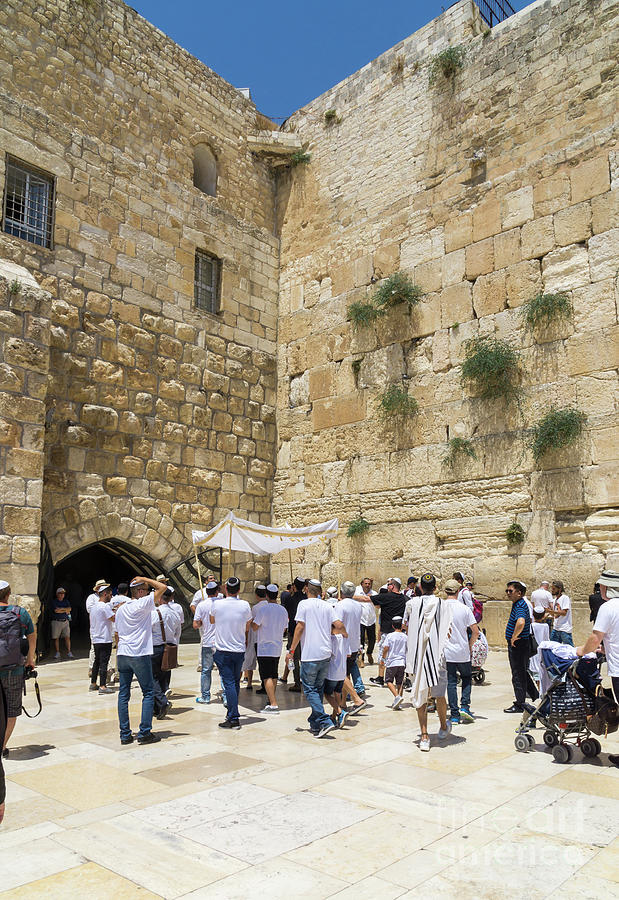 Men conduct a Bat Mitzvah celebration at the Western Wall in the Photograph by William Kuta