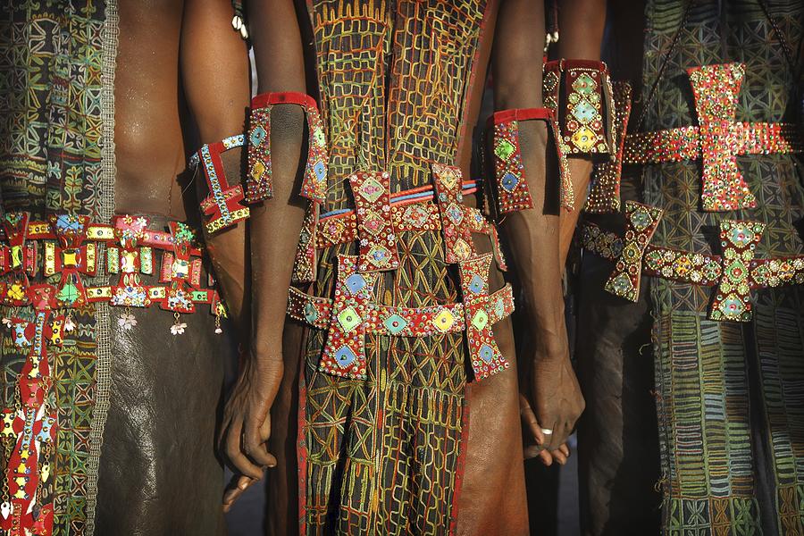 Men holding hands wearing tribal designs Photograph by Timothy Allen