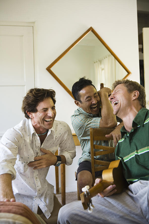 Men laughing and hanging out Photograph by Jupiterimages