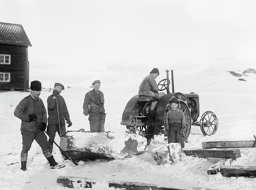 Men moving a rune stone at Vntholmen, Hilleshg, Uppland, Sweden ...