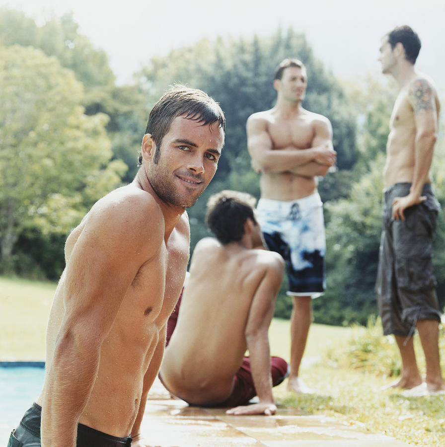 Men Poolside Photograph by Digital Vision.