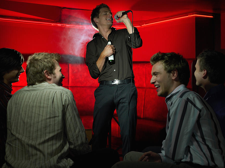 Men singing in a bar Photograph by Image Source