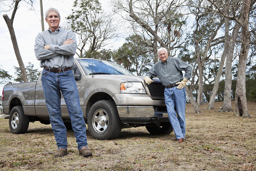 Men standing by pickup truck Photograph by Kali9