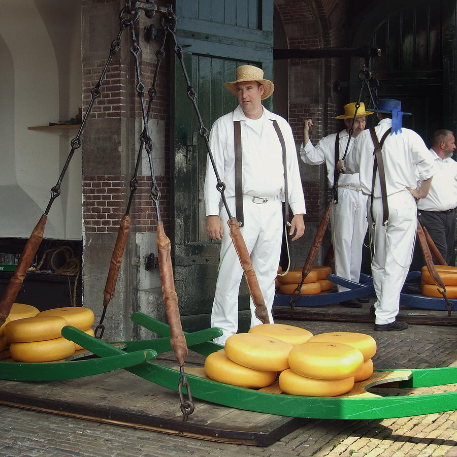 Men weighing cheese at Cheese Market in Alkmaars main square in the Netherlands Photograph by Photo by Victor Ovies Arenas