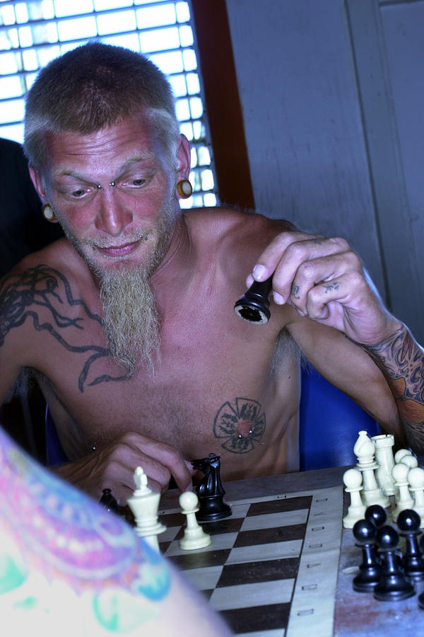 Men with tattoos playing chess Photograph by Thinkstock Images